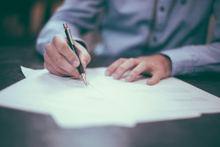 Person signing a legal document